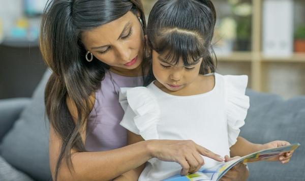 Image of mom reading to her daughter.