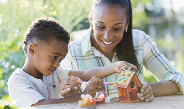Image of mother and son building a bird feeder.