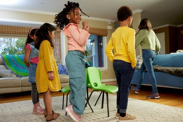 Four children play musical chairs.