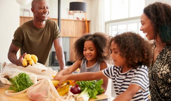 Family unpacking groceries together.