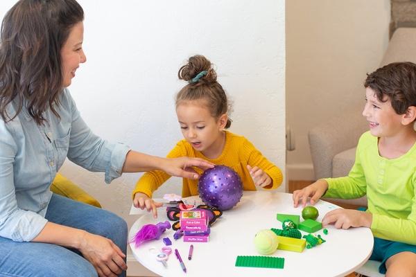 A mother and her children count objects together.