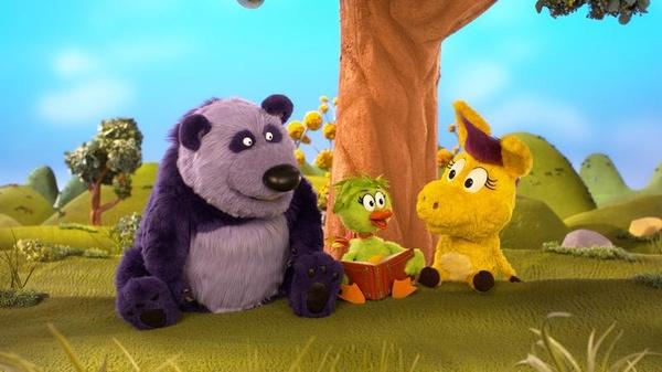 Purple Panda, Duck Duck, and Donkey Hodie sit under a tree reading a book.