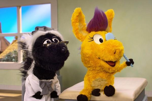 Donkey Hodie covers one eye for part of an eye exam.