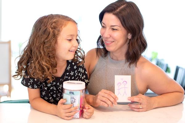 A parent and child with their gratitude jar.