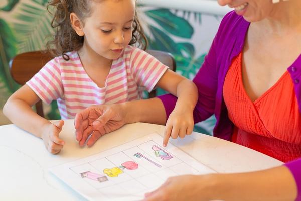 A mother and daughter go over their routine chart.
