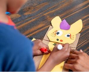 Child making a Donkey Hodie puppet.