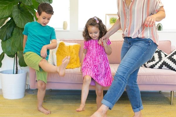 Children dancing with mom nearby