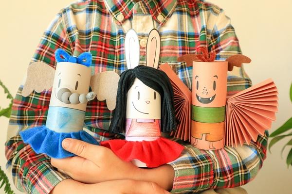 A child holds DIY ornaments inspired by “Elinor Wonders Why.”