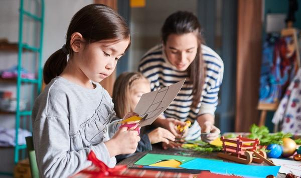 Young girl making gifts in arts and crafts class.