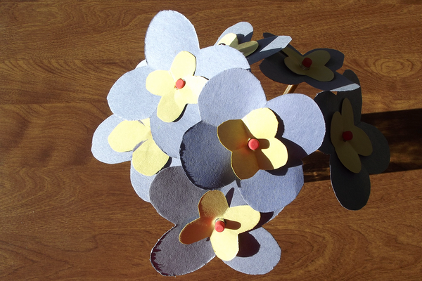 blue and yellow paper flower bouquet on table.