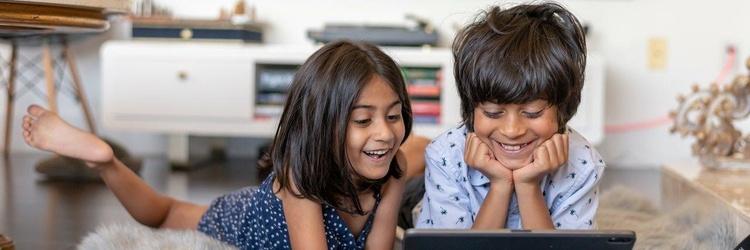 brother sister kids enjoying screen time.