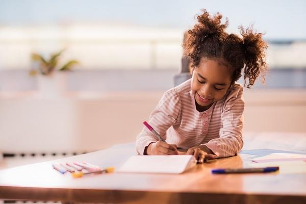 Girl writing on paper.