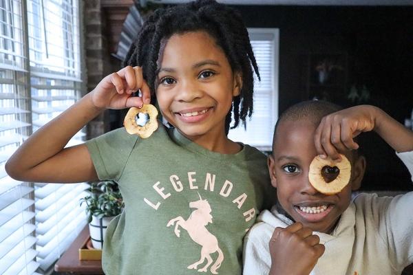 Kids showing off their finished apple heart chips.