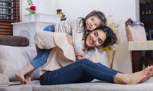 Mother and daughter hugging and smiling.