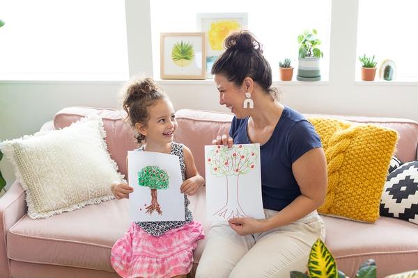 A parent and child look at their plant puzzles.