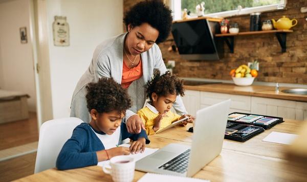 Mom helping kids with school work.