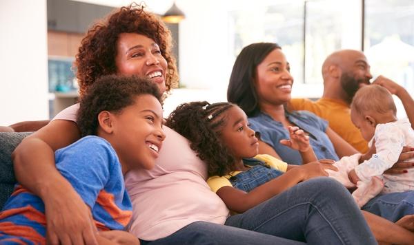 Multigenerational family watching television together.