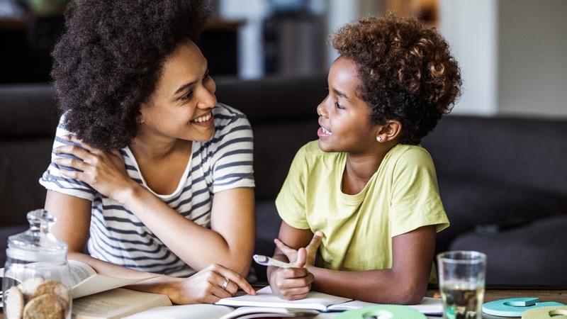 Mom and child looking through back to school papers and books.