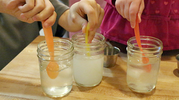 ice being stirred in three jars