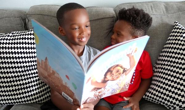 Image of two boys reading a book about Juneteenth.