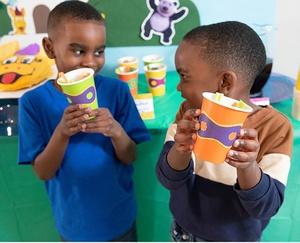Kids showing their veggie cups.