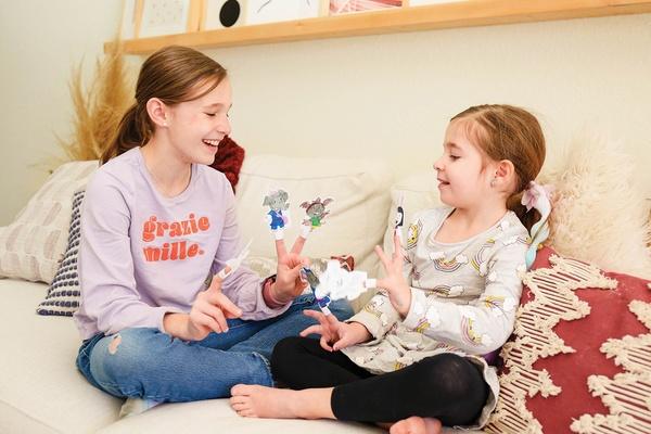 Finger puppets on the hands of two children