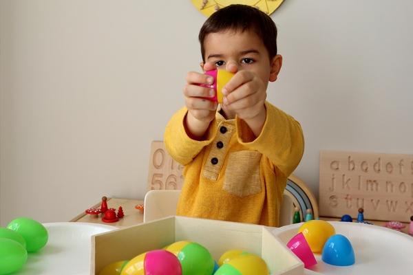 A child opens up an easter egg.