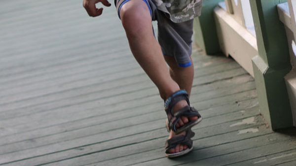 a child's legs in a skipping motion