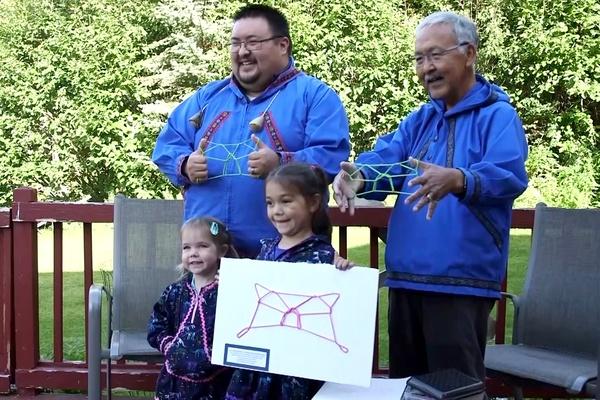 Three generations of an Alaska Native family participate in a family tradition of making string figures together.