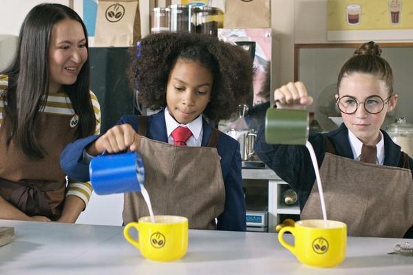 Two Odd Squad agents make coffees at a café.