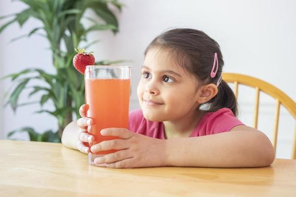 A girl admires her Pinkalicious pink lemonade.