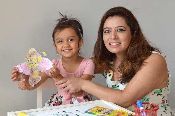 A mother and daughter hold up the pinkatastic creature they made together.