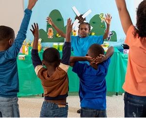 Children raising their hands in the air.
