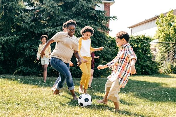 A family playing soccer together.