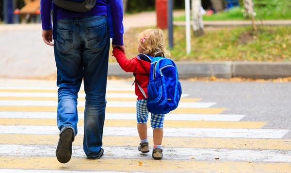 Father walking young daughter to preschool.