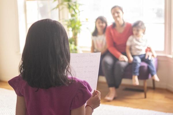 A child gives their speech in front of family and friends.