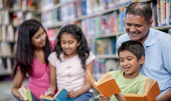 Family reading together at the library.