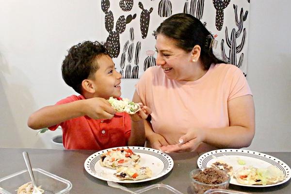 Family at the table eating tostadas.