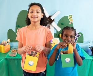 Kids holding favor bags.