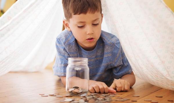 Young boy counting coins.