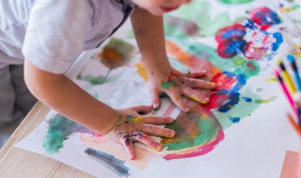 Child painting with his hands.