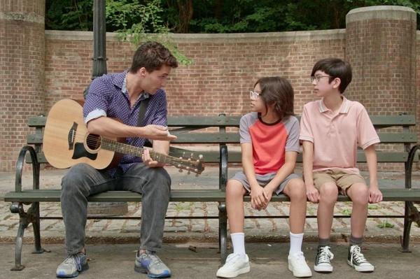 Tony and Tyler having a conversation with a guitarist.