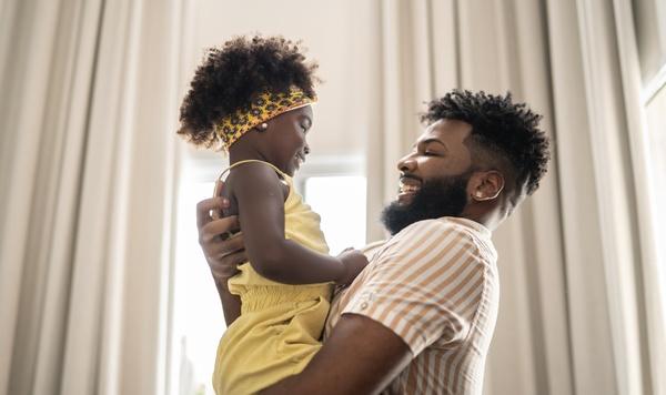 Father holding and hugging his daughter.