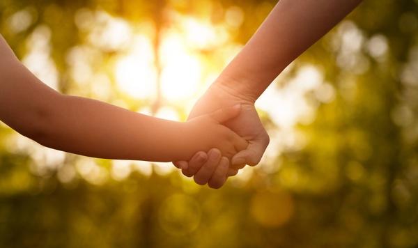 Parent and child holding hands.