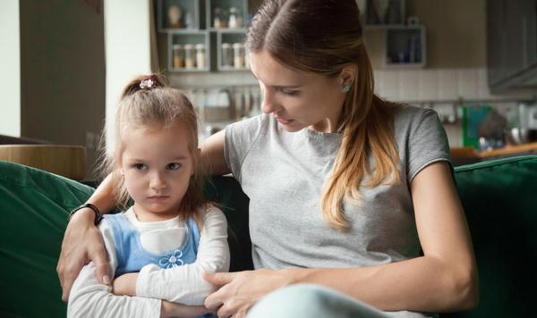Image of mother and daughter sitting on the couch.