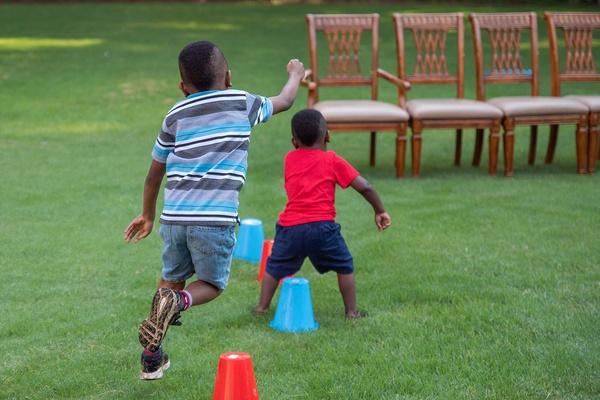 Two children participate in the creature power adventure games.