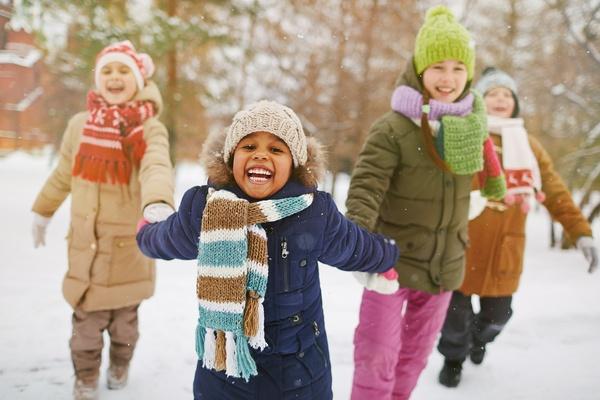 Children playing outside in snow