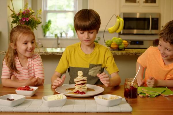 Children creating a pancake stack.