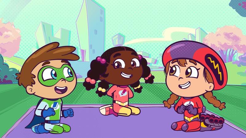 Super Why, Power Paige, and Wonder Red are sitting on a picnic blanket in the park.