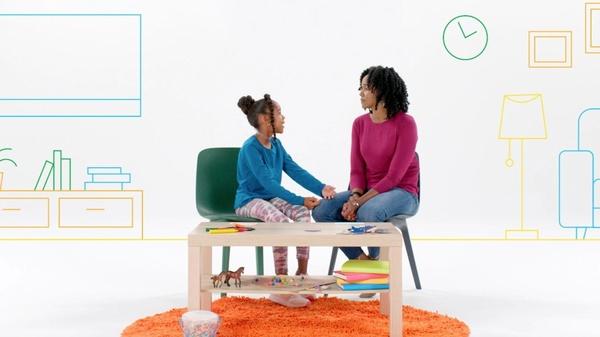 Mom and daughter sitting in chairs talking.